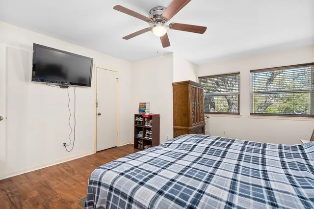 a bedroom with a bed and a flat screen tv