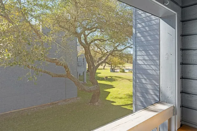 a view of an empty room and a window