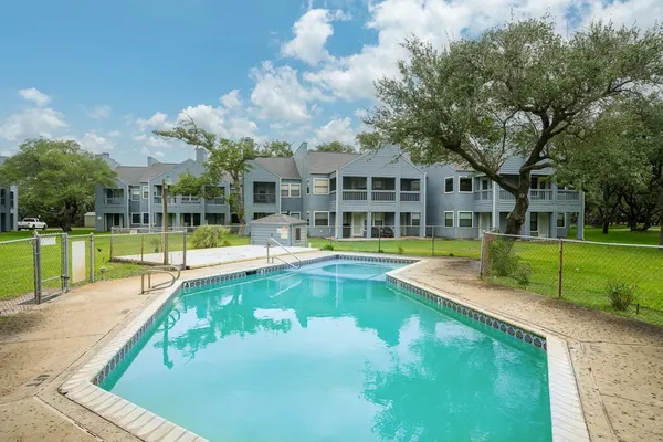 a view of a house with swimming pool and a yard
