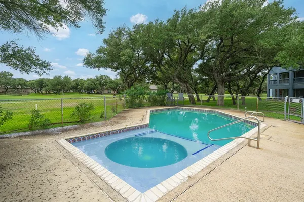 a view of a swimming pool and a yard