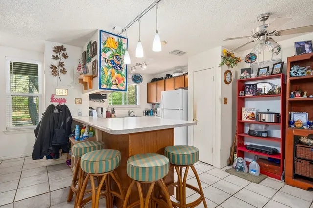 a view of a dining area with furniture and a kitchen