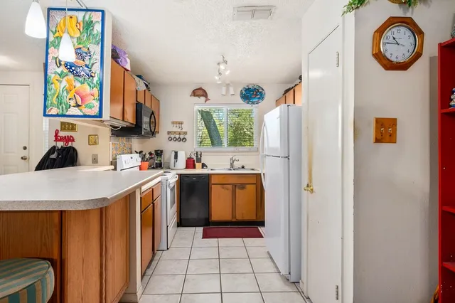 a kitchen with stainless steel appliances granite countertop a refrigerator and a stove