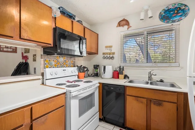 a kitchen with a sink cabinets and window
