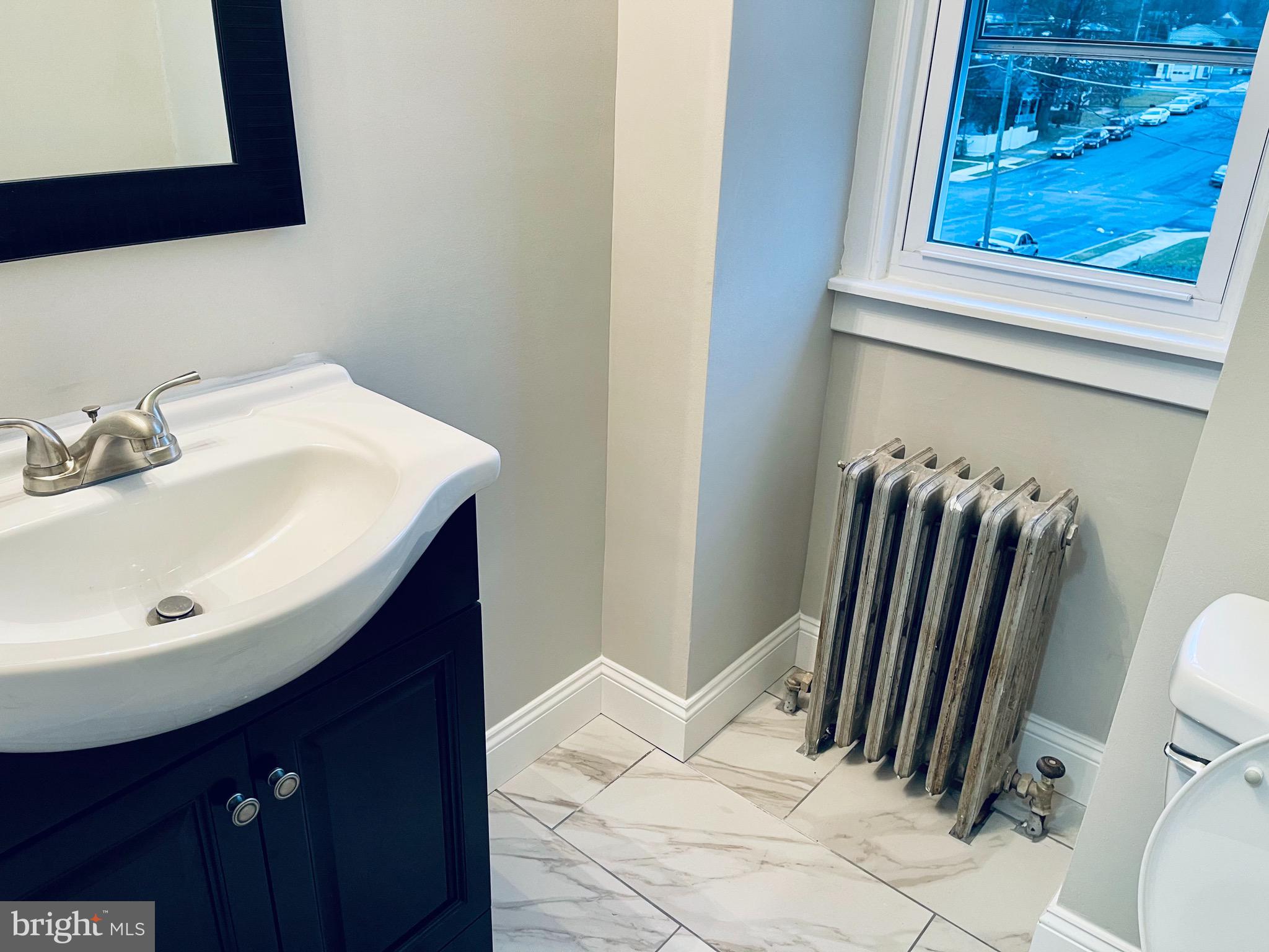 304 Haig Boulevard Reading, PA 19607 - Photo 22 of 27 a bathroom with a sink and a mirror