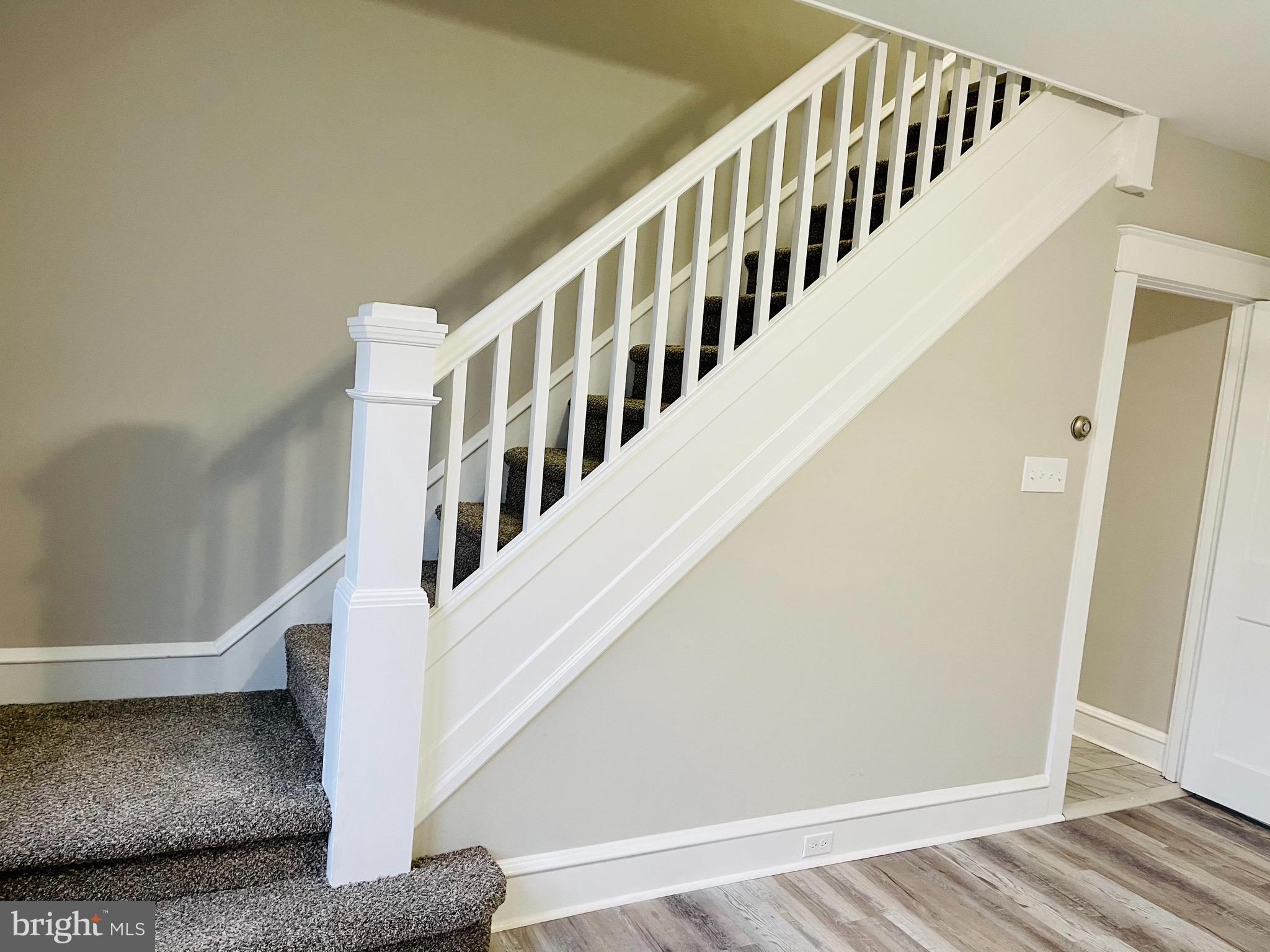 304 Haig Boulevard Reading, PA 19607 - Photo 9 of 27 a view of staircase with lots of frames on wall and wooden floor