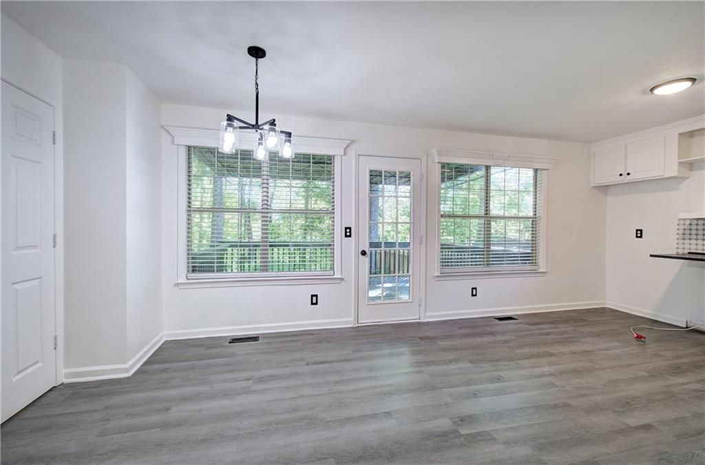 22 Nottingham Drive Northwest Cartersville, GA 30121 - Photo 12 of 36 a view of an empty room with wooden floor and a window