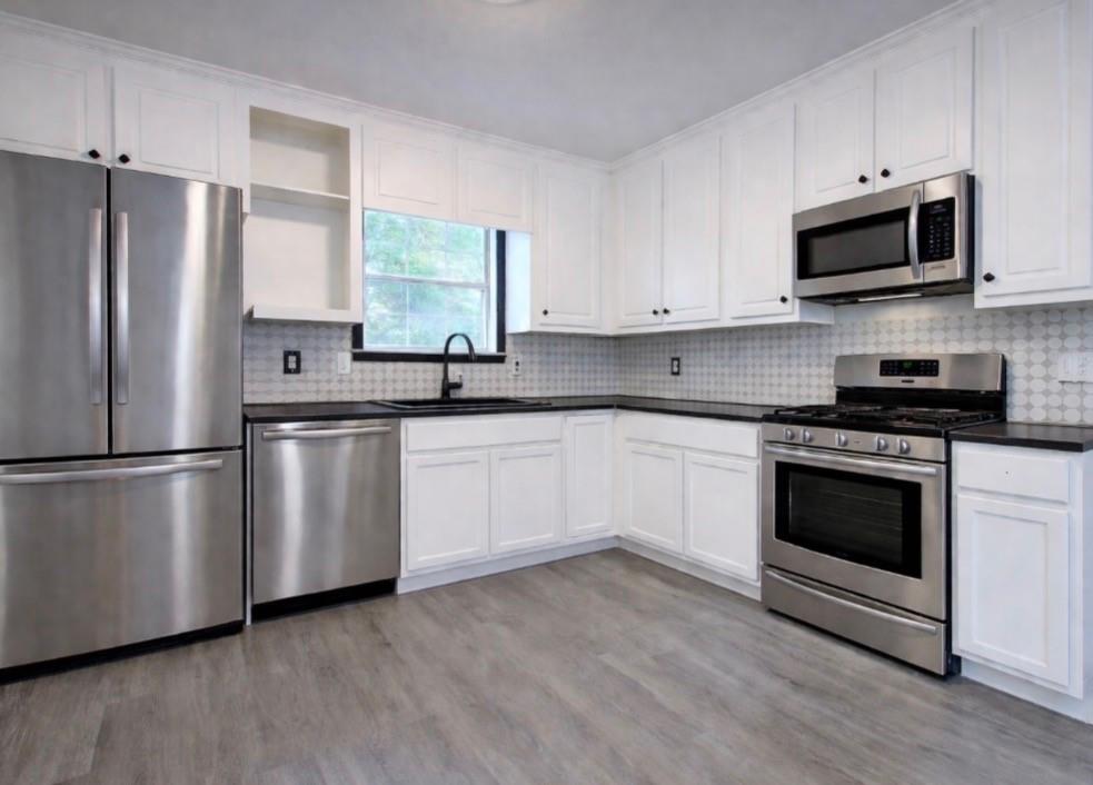 22 Nottingham Drive Northwest Cartersville, GA 30121 - Photo 14 of 36 a kitchen with white cabinets white stainless steel appliances and sink