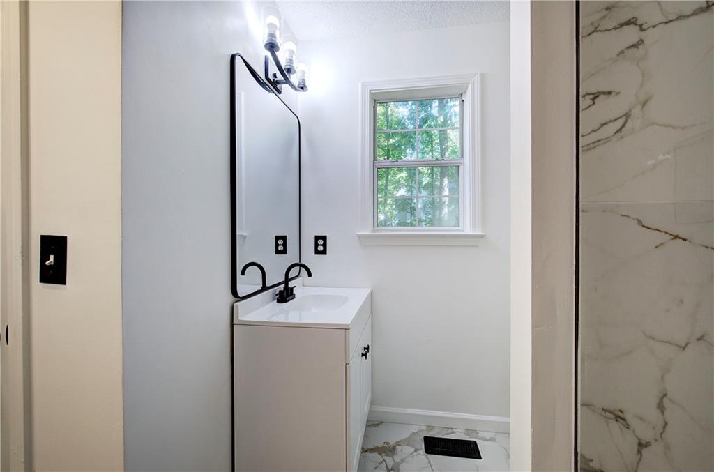 22 Nottingham Drive Northwest Cartersville, GA 30121 - Photo 22 of 36 a bathroom with a sink a toilet and a mirror