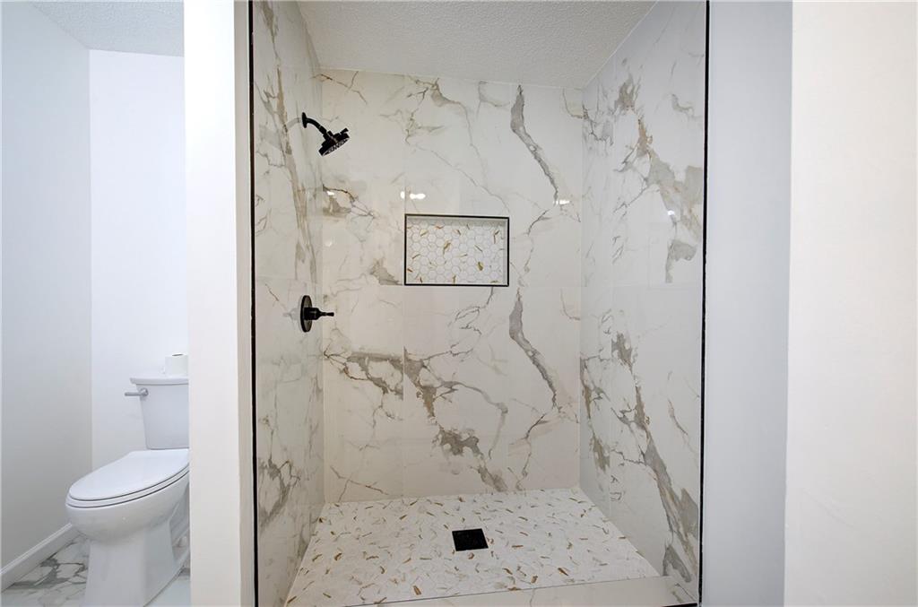 22 Nottingham Drive Northwest Cartersville, GA 30121 - Photo 23 of 36 a bathroom with a toilet and a shower