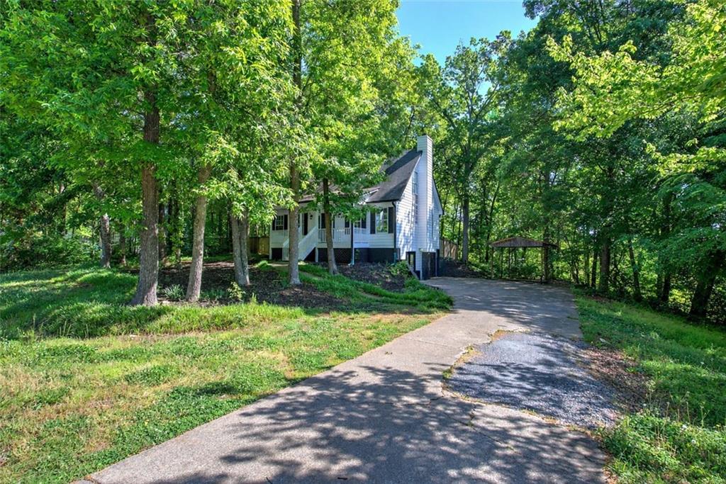 22 Nottingham Drive Northwest Cartersville, GA 30121 - Photo 4 of 36 a view of a big yard with plants and large trees