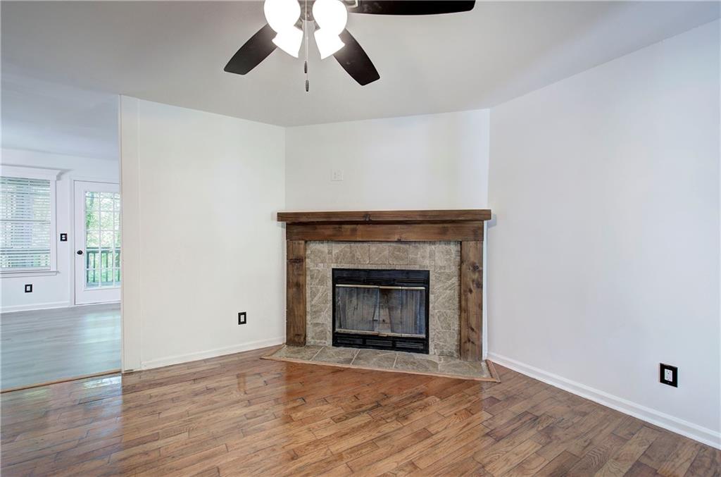 22 Nottingham Drive Northwest Cartersville, GA 30121 - Photo 10 of 36 a view of an empty room with wooden floor and a fireplace