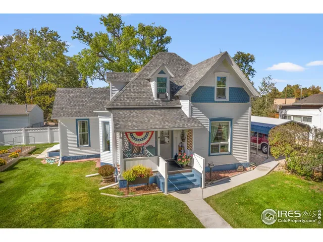 a front view of a house with a yard table and chairs