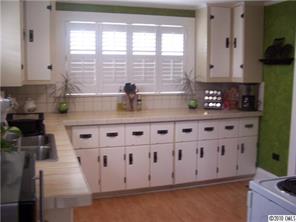 182 Weisner Road Olin, NC 28660 - Photo 6 of 10 a kitchen with stainless steel appliances granite countertop a sink a stove and a wooden cabinets