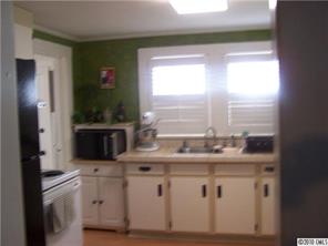 182 Weisner Road Olin, NC 28660 - Photo 7 of 10 a kitchen with stainless steel appliances granite countertop a sink a stove and a refrigerator