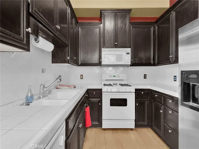 a kitchen with a sink a stove and cabinets