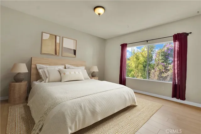 a bedroom with a large bed and a large window