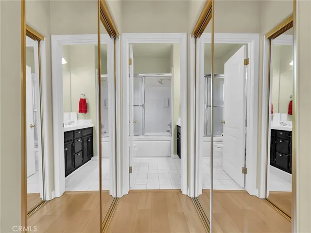a view of a hallway with wooden floor and staircase