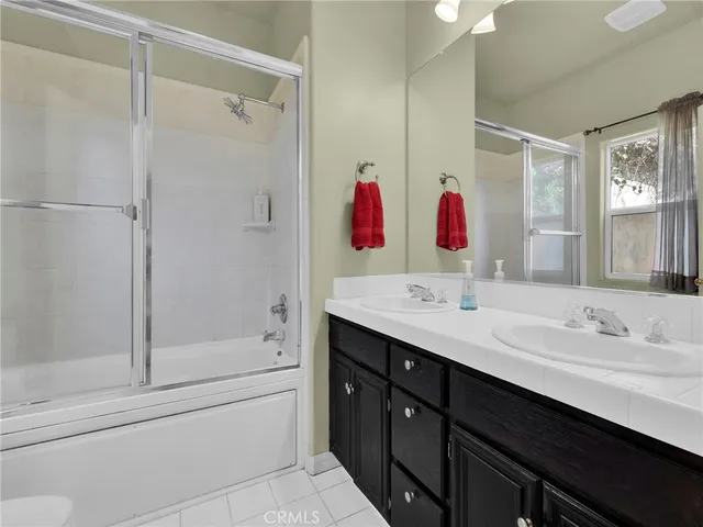 a bathroom with a tub sink mirror and vanity