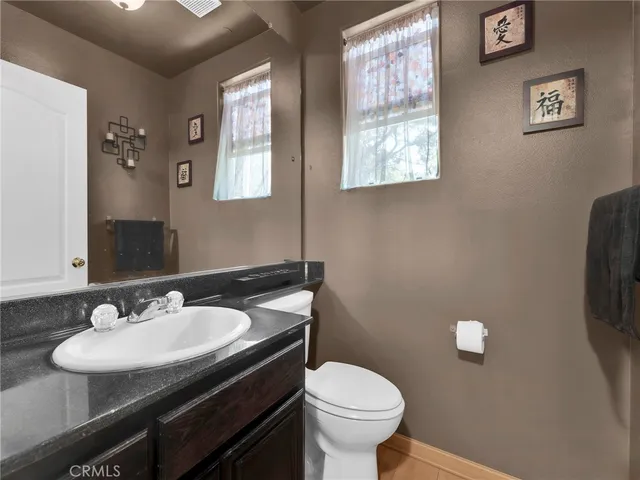 a bathroom with a sink toilet and a mirror