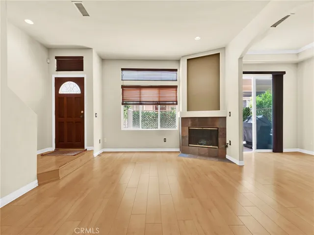 wooden floor fireplace and natural light in room