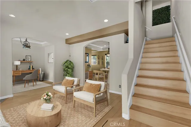 a living room with furniture and a chandelier