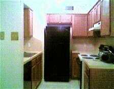 7252 Mansions Drive, Unit R4 Corpus Christi, TX 78414 - Photo 3 of 8 a kitchen with a refrigerator and a stove