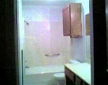 7252 Mansions Drive, Unit R4 Corpus Christi, TX 78414 - Photo 5 of 8 a bathroom with a granite countertop sink a mirror and shower