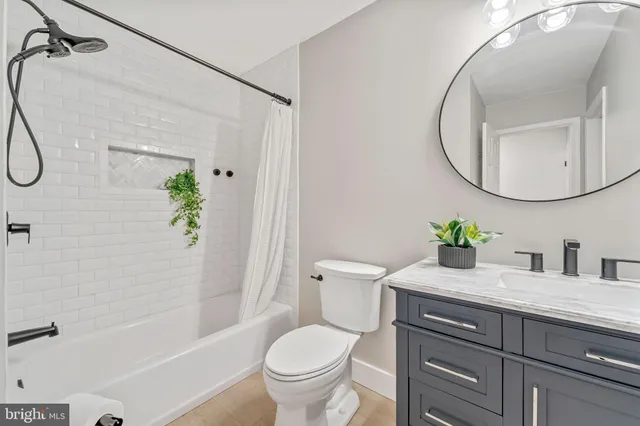 a bathroom with a granite countertop toilet sink and shower