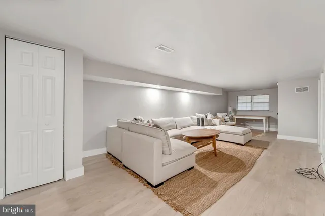 a living room with furniture and a lamp