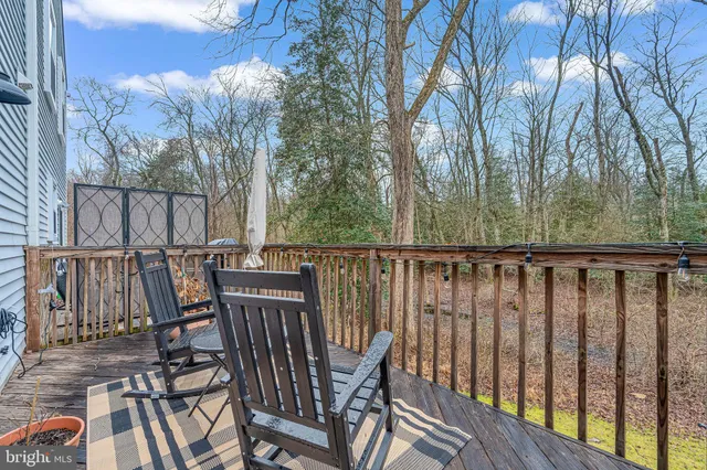 a view of balcony with furniture and trees around