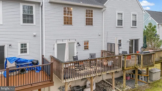 a view of a house with wooden deck
