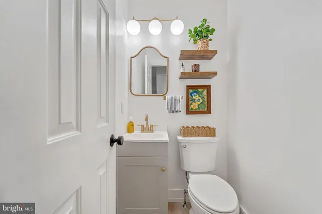 a white toilet sitting next to a bathroom sink