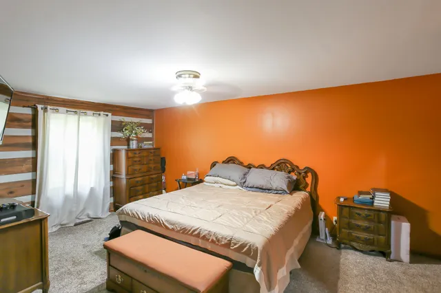 a bedroom with a bed and window