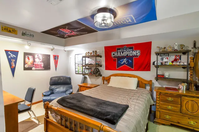 a bedroom with a bed and dresser