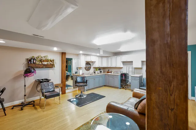 a living room with furniture and kitchen view