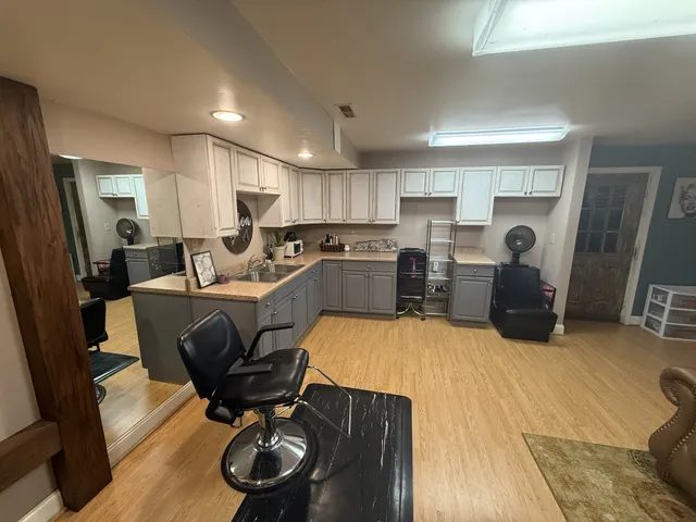 a living room with furniture and kitchen view