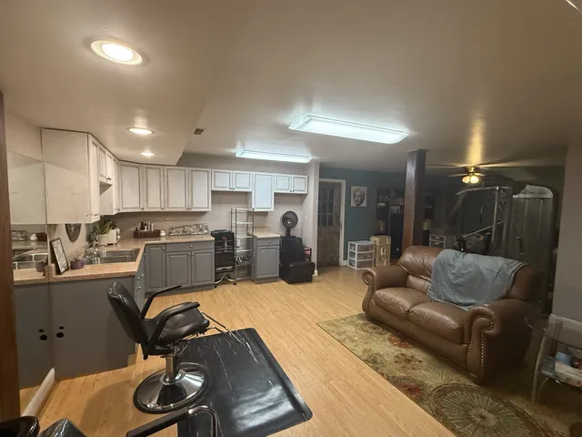 a living room with furniture rug and kitchen view