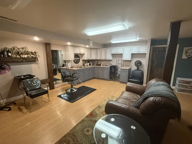 a view of a livingroom with workspace and a couch