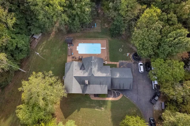 an aerial view of a house with swimming pool