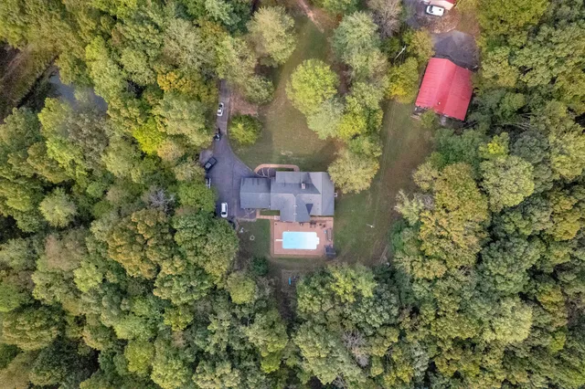 a aerial view of a house with a yard and lake view
