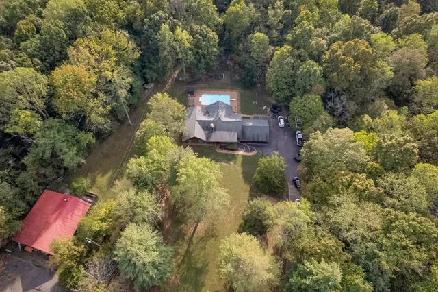 a swimming pool with trees in the background