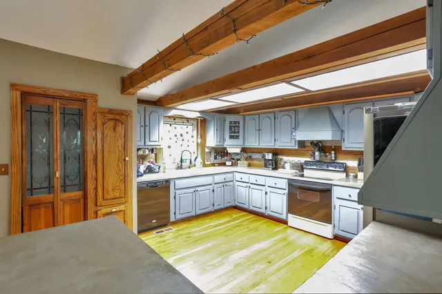 a kitchen with stainless steel appliances granite countertop a sink and cabinets