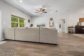 5573 Casavedra Court Jacksonville, FL 32244 - Photo 13 of 34 a living room with furniture and a large window