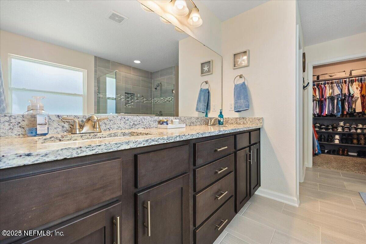 5573 Casavedra Court Jacksonville, FL 32244 - Photo 16 of 34 a bathroom with a granite countertop sink mirror and double