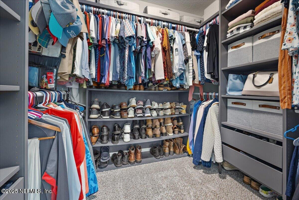 5573 Casavedra Court Jacksonville, FL 32244 - Photo 18 of 34 a view of walk in closet with clothes and shoes