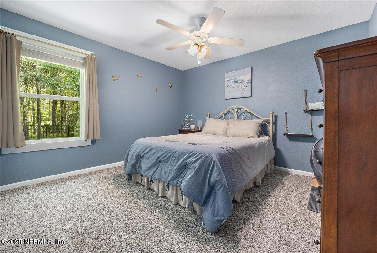 5573 Casavedra Court Jacksonville, FL 32244 - Photo 20 of 34 a bedroom with a bed and a large window