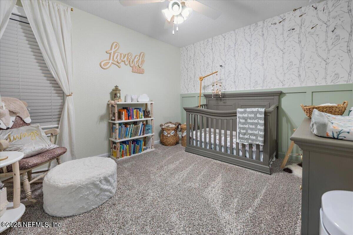 5573 Casavedra Court Jacksonville, FL 32244 - Photo 21 of 34 a bedroom with furniture and a book shelf