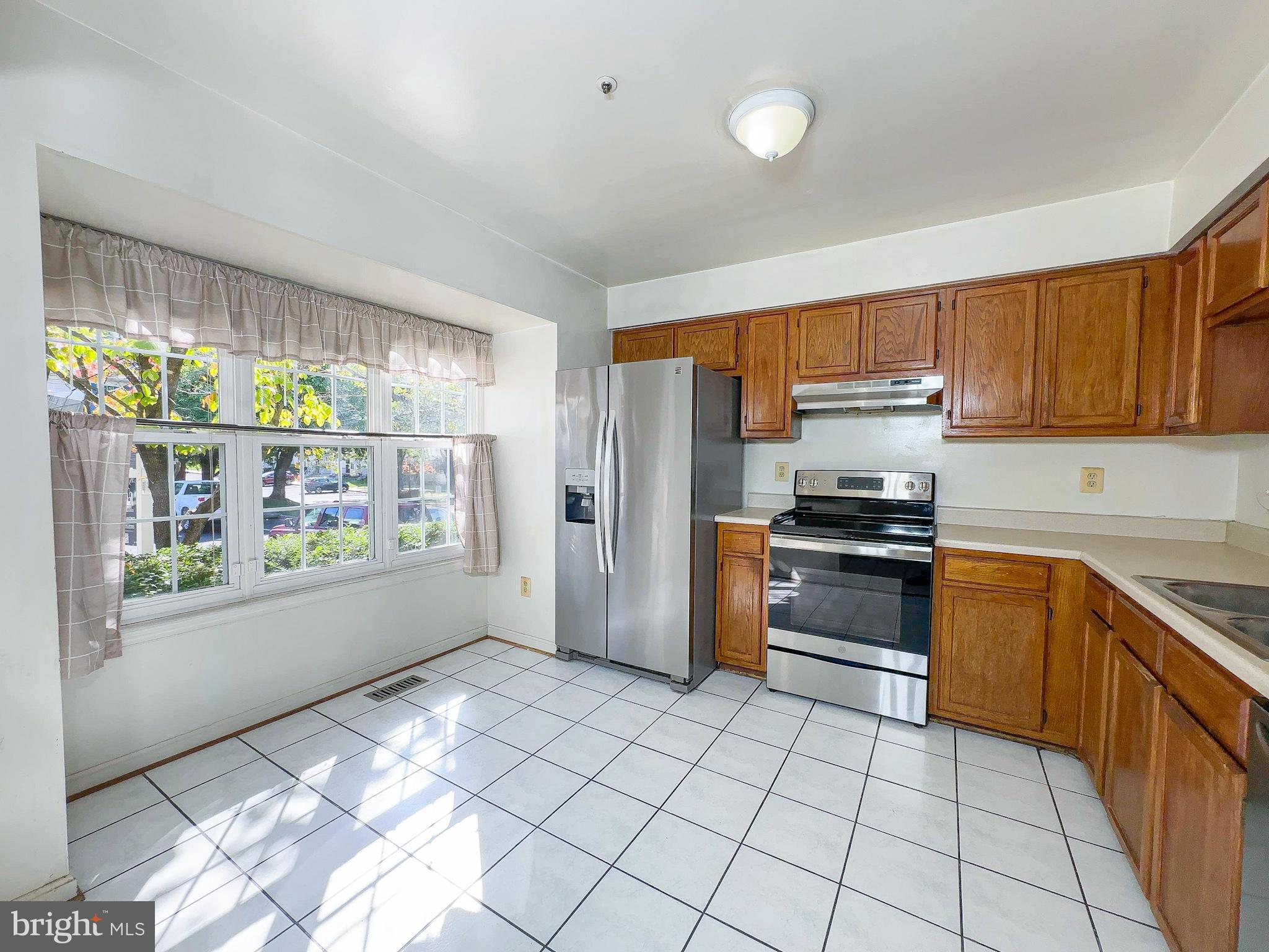 8578 Ritchboro Road District Heights, MD 20747 - Photo 1 of 31 a kitchen with stainless steel appliances a stove a sink and a refrigerator
