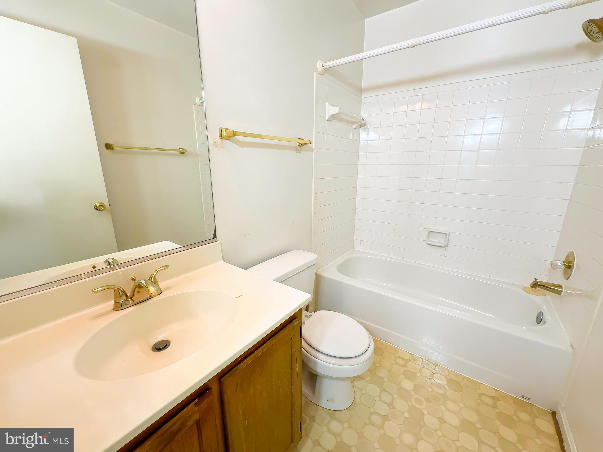 8578 Ritchboro Road District Heights, MD 20747 - Photo 20 of 31 a bathroom with a bathtub shower sink vanity and toilet