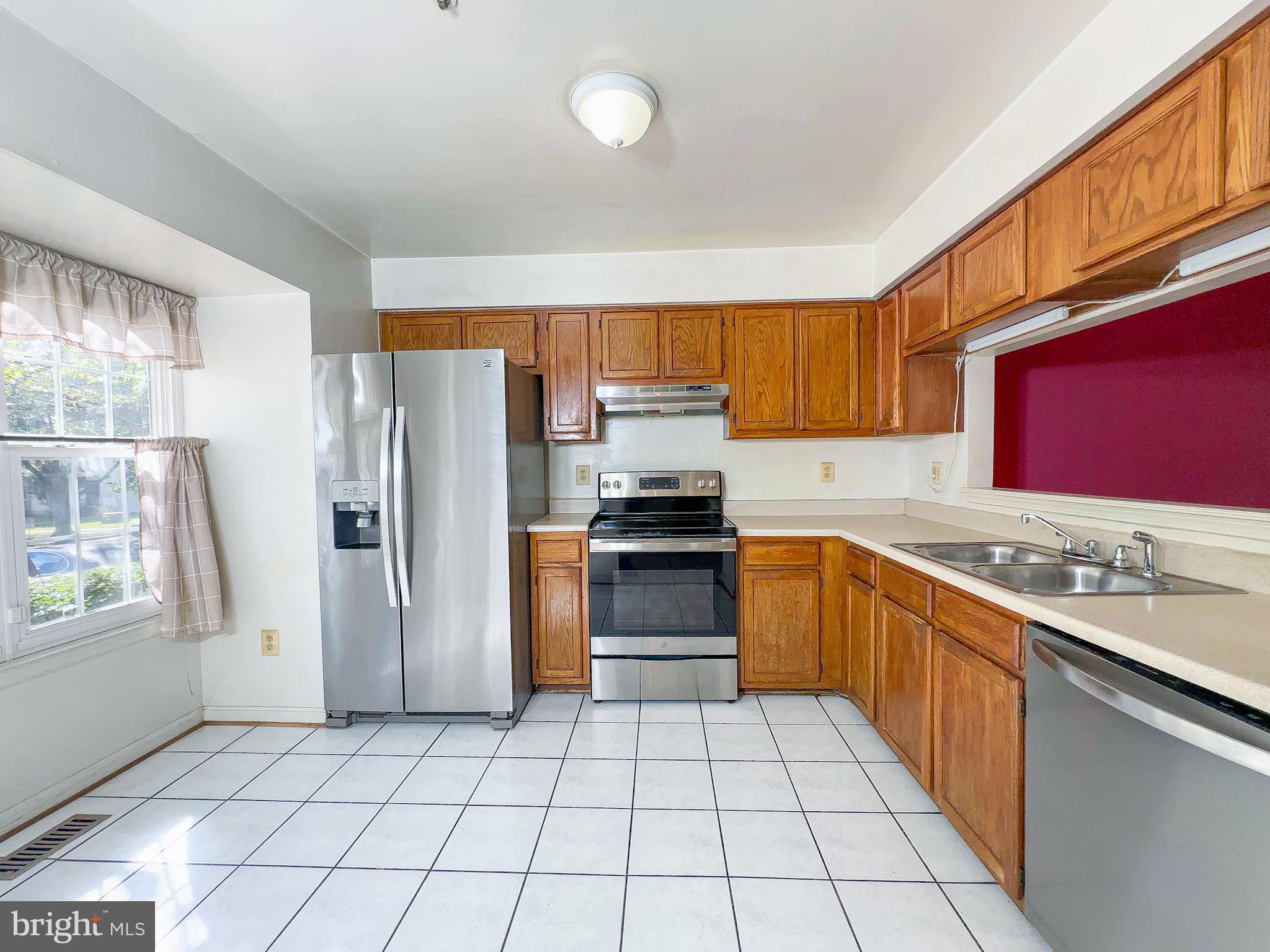 8578 Ritchboro Road District Heights, MD 20747 - Photo 4 of 31 a kitchen with stainless steel appliances granite countertop a refrigerator and a stove top oven